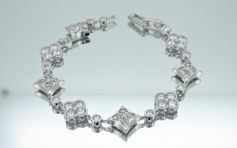 Trang Sức Cỏ 4 Lá - Biểu Tượng May Mắn Và Phong Cách Của Thời Trang Cao Cấp 4 Lắc Tay Trang Sức Cỏ 4 Lá Đính Đá Toàn Bộ Lấp Lánh Trên Nền Xám Bạc Hiện Đại.